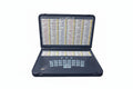 A digital educational device with a keyboard and screen, displaying rows of text which seem to be verses from the Quran, placed in an open position.